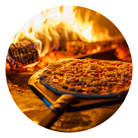 Wood-fired pizza baking in a hot oven.
